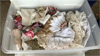 2 tubs of table covers, doilies, etc