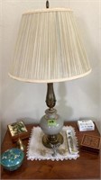 Lamp and items on top of table: bell, music box,