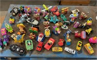 Table full of McDonalds toys / cars