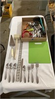 Kitchen utensils, silverware, cutting board