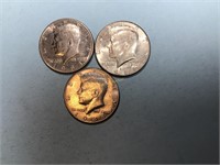 Three Kennedy half dollars