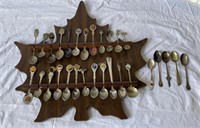 Souvenir spoons on maple leaf shaped board- F