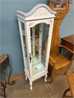 Small lighted curio cabinet with glass shelves