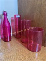 Group of four cranberry colored glass vases