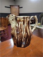 BROWN AND CREAM PITCHER W/ FACE OF GOD