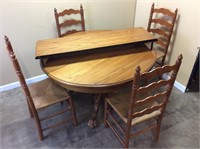 GOLDEN OAK DINING TABLE & 4 LADDER BACK CHAIRS