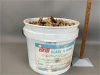 Bucket full of mostly wooden clothes pins