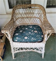 Wicker chair with cushion. 33" back, 30" wide. 19"