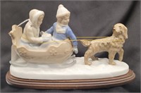 Meico ceramic dog sled figurine on wood stand.