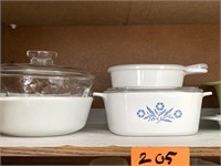 Shelf of Corning and Pyrex dishes.