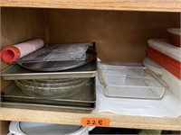 Shelf of misc baking sheets and pans.