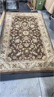 Brown and tan Oriental rug 5 x 8