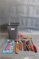 Plastic  trash can with assorted tools