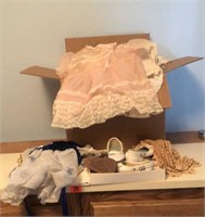 Box of vintage baby clothes, shoes, linens