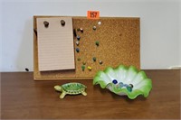 Bulletin board, ceramic turtle, dish of marbles