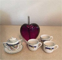 Glass heart, miniature teacups and creamer dish