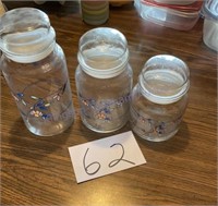 Three glass canisters