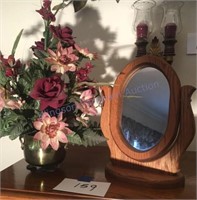 Oak mirror and floral arrangement