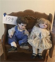 Two dolls on bench