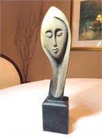 Wood carved woman in repose statue
