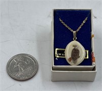 Scrimshawed walrus tooth pendant on a short chain