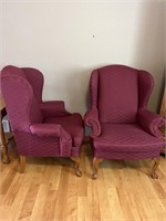 Two matching maroon wingback chairs