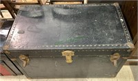 Large black leather trunk with metal studs,