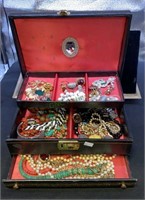 Vintage jewelry box filled with costume jewelry,