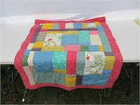 Crib quilt **has small rip on the backside**