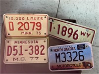 4 vintage motorcycle license plates.