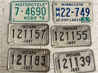 6 old motorcycle license plates.