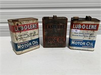 3 Vintage Motor Oil Cans. One has some oil in it.