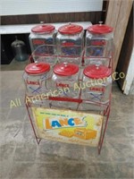 VTG LANCE DISPLAY RACK W/SIGN & 6 GLASS LANCE JARS