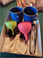 Box with two blue tin cups, two funnels,