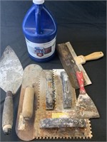 Various concert and mason tools and 3/4 jug of