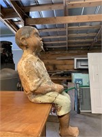 Repaired little boy yard statue