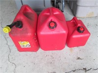 three empty gas cans
