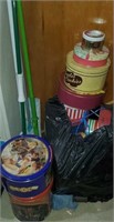 A bag full of various tins and mops