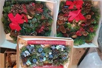 Pair of Christmas wreaths and candle holders