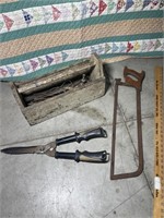 Old toolbox hedge trimmers and meat saw