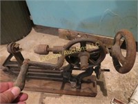 antique drill press hand crank mounted on wood