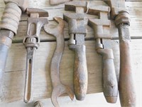 5 pipe wrenches, hatchet head, and wrench