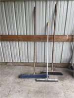 2 push brooms and squeegee