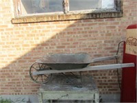 Antique steel wheeled wheel barrow.
