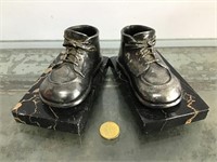 Metal baby shoes on granite