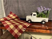 Decorative Truck Flower Arrangement & Checked Rug