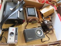 assorted cameras binoculars radio
