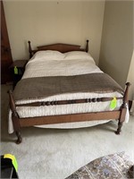 mid-century hardwood bed with bedding