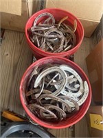 2 buckets of horse shoes