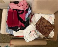 3 boxes of linens, fabric, and quilting board